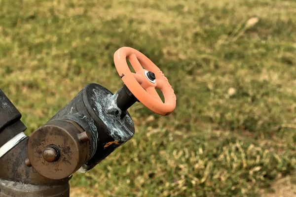 A water pipes on the green grass — Stock Photo, Image