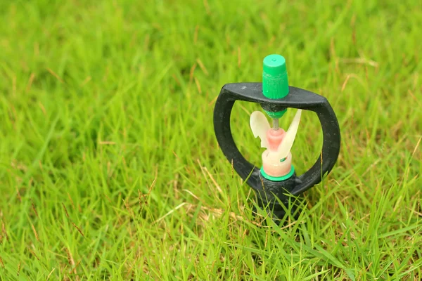 Sprinkler is stuck in in the grass. — Stock Photo, Image