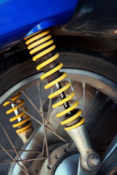Shock absorbers of yellow motorcycles at the park — Stock Photo, Image