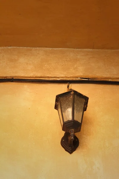 A lamp on a wall on brown background. — Stock Photo, Image