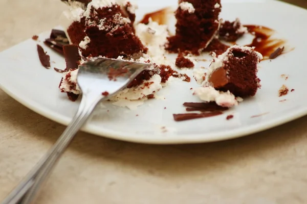 Chocolate cake on a white plate with a fork. — Stock Photo, Image