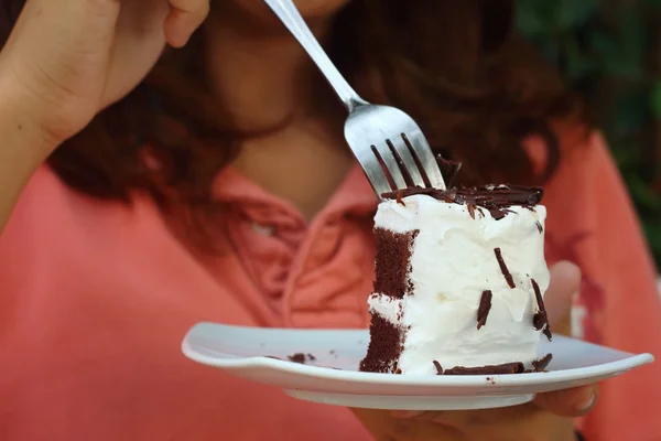 Vrouw eten chocolade taart in een cafe. — Stockfoto