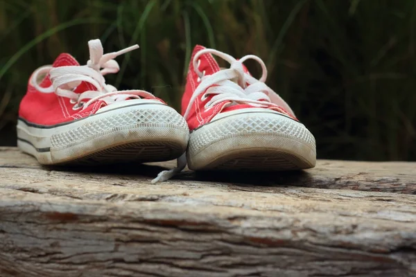 Red shoes on a background of brown wooden — Stock Photo, Image