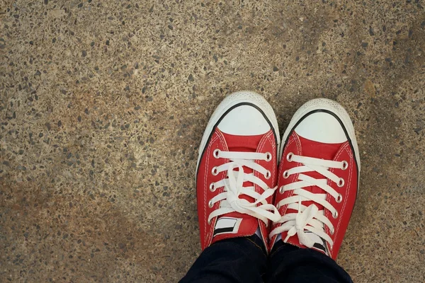 Red shoes on the background of the cement. — Stock Photo, Image