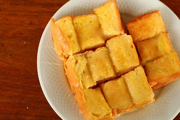 Toast with butter and sprinkling with sugar — Stock Photo, Image