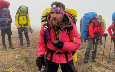 Deneyimli bir turist rehberi elinde bir seyir subayıyla grubunu nereye götüreceğini düşünür. Dağ tırmanışı. Klyuchevskoy volkan parkında gezinti. Kamçatka Yarımadası 'na git..