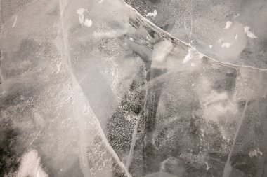 Buzun güzel soyut çizimi. Tavan penceresinde inanılmaz buz parçaları var. Çatlakları karla kaplı şeffaf buz. Kış doğal arka plan. Baykal Gölü 'nün donmuş mırıltıları.