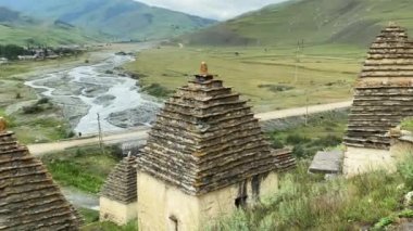 Alanların antik mezarlığı. Dargavs Köyü - Ölüler Şehri, Kuzey Osetya, Rusya. Dağın yamacında duran küçük taş anıtlardan oluşan bir manzara..