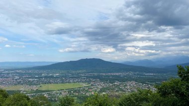 Lysaya Gora 'daki gözlem güvertesinden nefis bir manzara. Kuzey Osetya 'nın güzel doğası. Görkemli dağlar, yeşil tepeler ve sonsuz gökyüzü.