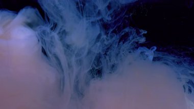 Siyah arka planda suluboya mürekkep. Sıvı mavi ve beyaz boyaların yavaş hareketi. Kozmik büyü geçmişi. Güzel soyut arkaplan.