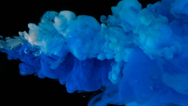 Blue and white watercolor paints in water on a black background. Awesome abstract background. Beautiful wallpaper for your desktop. Blue cloud of ink on a black background. Drops of blue ink in water.