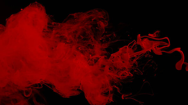 Red cloud of ink. Awesome abstract background. Drops of red ink in water. Cosmic star background. Red watercolor paints in water on a black background. Beautiful wallpaper for your desktop.