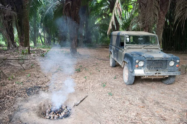 The off-road vehicle by the fireplace in Belize jungle.