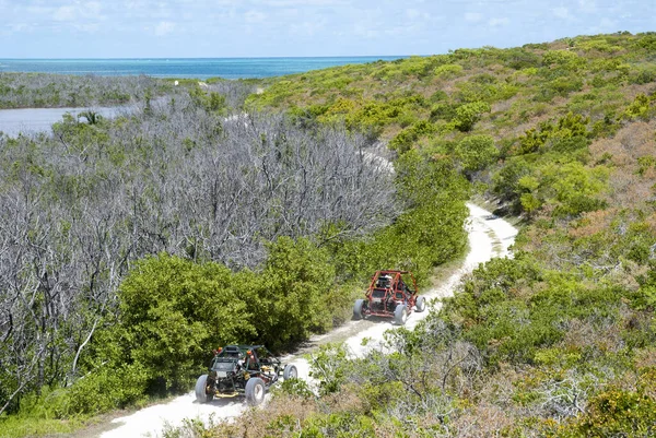 Tourists traveling by go-karts around Grand Turk island (Turks and Caicos Islands).