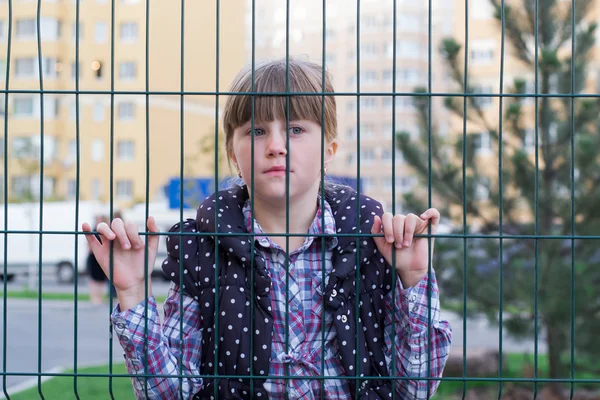 Girl behind bars — Stock Photo, Image