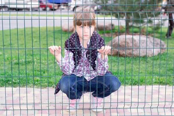 Девушка за решеткой — стоковое фото