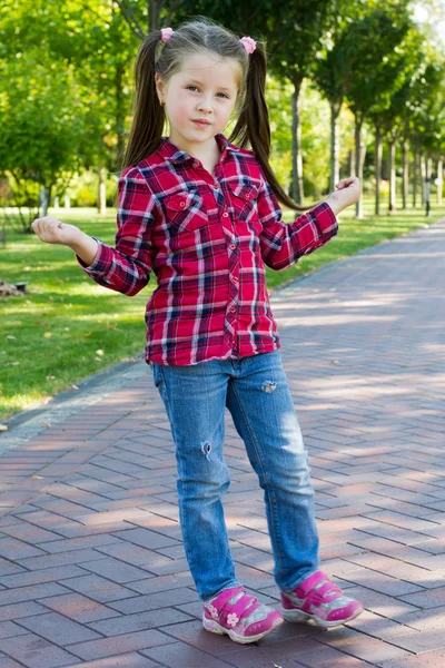 Girl with pigtails in jeans — Stock Photo, Image
