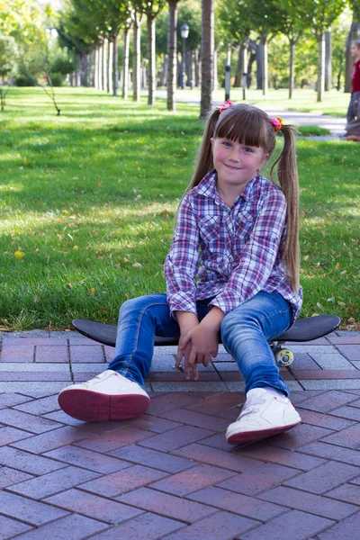 Girl with pigtails in jeans — Stock Photo, Image