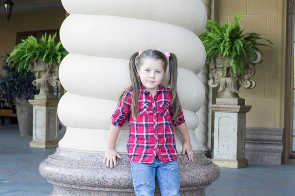 Girl with pigtails in jeans — Stock Photo, Image