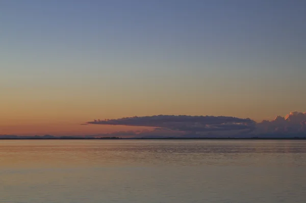 Clouds at sunset over the water — Φωτογραφία Αρχείου