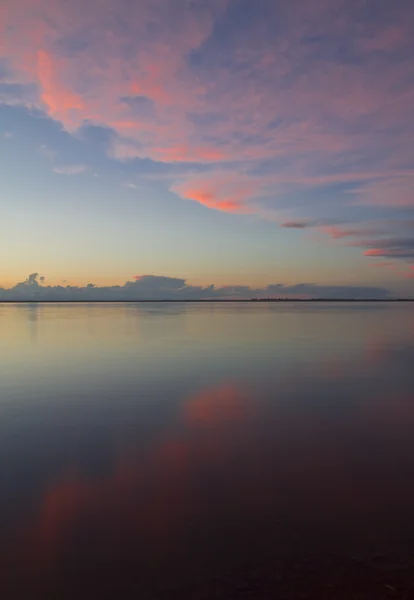 stock image Clouds at sunset over the water