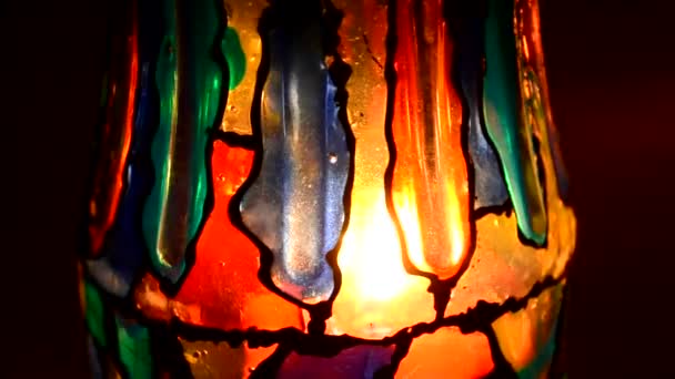 Candle inside a motley stained glass — Stock Video