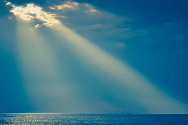 rays of the sun, water surface on sky background