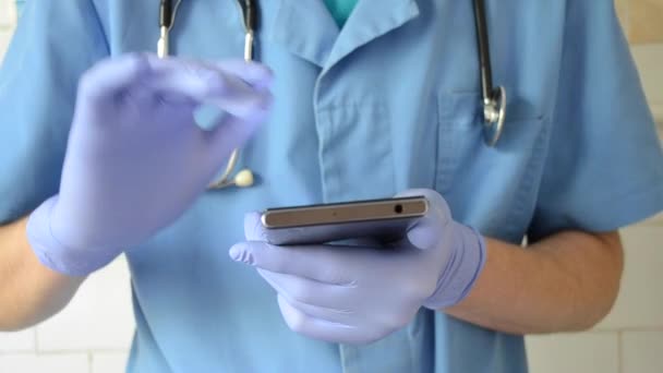 Medical doctor holding a phone and using it — Stock Video