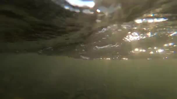 Fast movement of water with moving rays of sun on surface of water and in water. — Stock Video