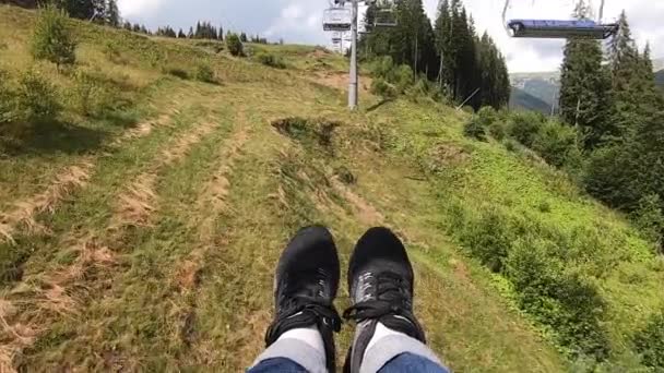 Menina cavalga ou sobe no elevador ou teleférico montanha acima. — Vídeo de Stock