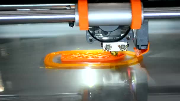 3d printer prints orange object model orange color close-up. — Stock Video