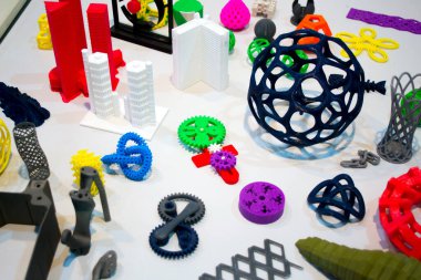 Soyut modeller 3D yazıcı tarafından yakın plan basıldı. Beyaz bir masadaki 3D yazıcıya basılmış parlak renkli nesneler. İlerici modern katkı teknolojisi. 4.0 sanayi devrimi kavramı