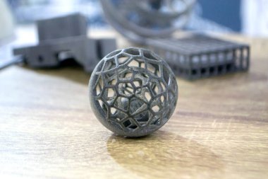 Podyum tozunun 3D yazıcısında yakın plan çekilmiş bir nesne. Termoplastik gri renkten üç boyutlu model. Hızlı prototip, baskı ürünleri. İlerici modern katkı teknolojisi