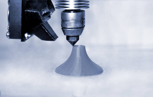 Modern 3D printer printing figure blue colors close-up