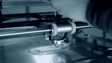 3D yazıcı turuncu nesneyi yakın plan basıyor. Otomatik üç boyutlu 3D yazıcı