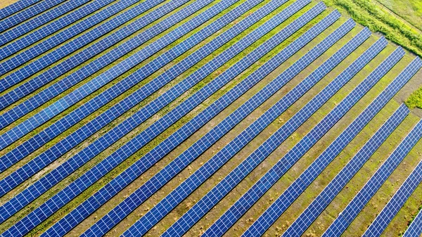 Aerial drone view flight over solar power station panels.