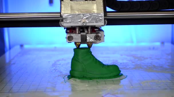 A 3D nyomtató az olvadt műanyag zöld formáját nyomtatja. — Stock videók