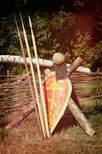 Samara, Russia, the festival of historical reconstruction ancient Russia ages 11-13 - August 11, 2013 - three spear, shield and helmet with a cross near the braided fence — Stock Photo, Image
