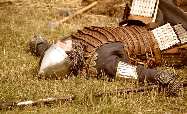 Samara, Russia, the festival of historical reconstruction ancient Russia ages 11-13 - August 16, 2013 - : soldier in armor lying on the ground — Stock Photo, Image