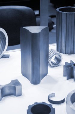 Beyaz bir yüzeyde farklı metal modeller. Birçok metal ürünü yakın planda. Vitesin çeşitli metal parçaları. Vites tekerlekleri. Metal işleme. Endüstriyel metal nesneler. Çelik imalatı