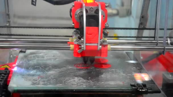 Red 3D printer prints red smilies — Stock Video
