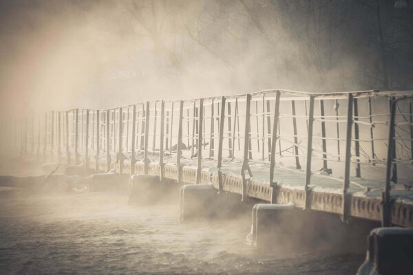  bridge made of concrete blocks  over the river in winter