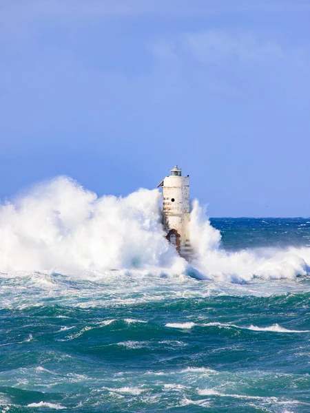 Big storm with big waves near a lighthouse