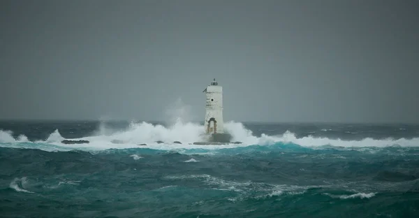 Big storm with big waves near a lighthouse