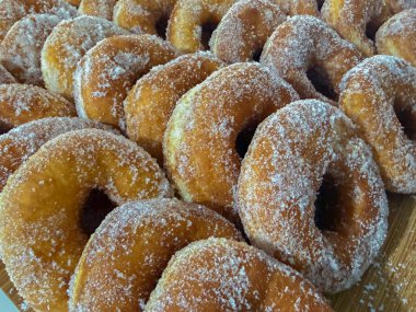 Tahtada şekerle kaplanmış taze kızarmış çörekleri kapat.