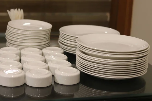 ceramic plates and bowl arrange on table at restaurant dinning hall
