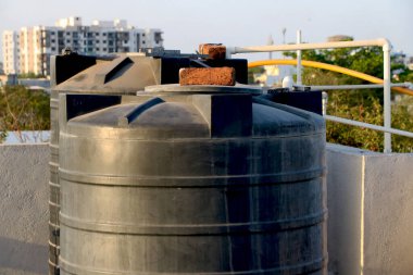 Çatıda tuğla kaplı büyük bir su tankı var.