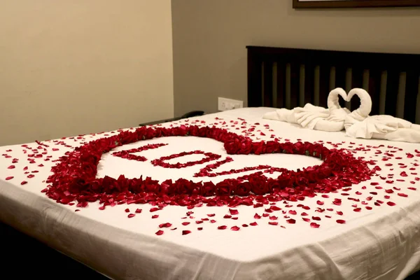 Honeymoon room (First night room) decoration with flower petals on bed