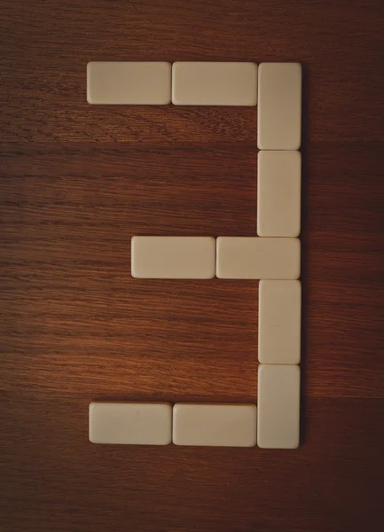 Number three laid out the domino chips — Stock Photo, Image