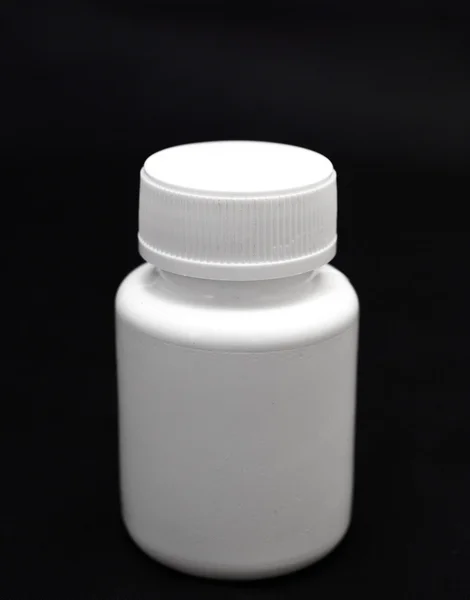 Bottle of pills on black — Stock Photo, Image